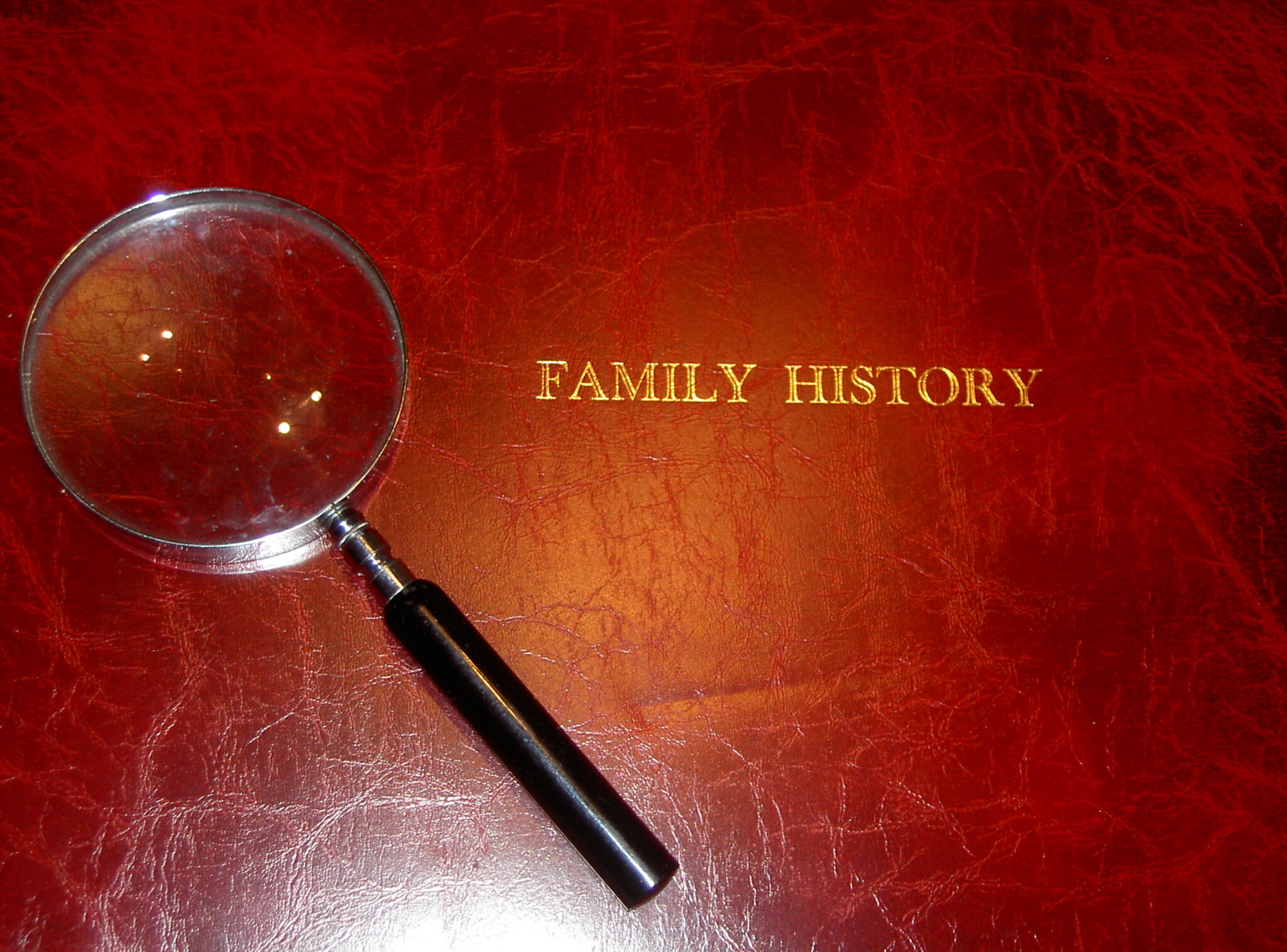 Family History binder and magnifying glass
